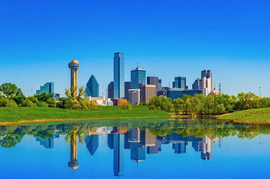 Dallas skyline with blue sky and water reflection in spring