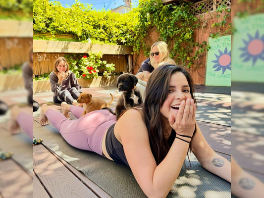 A Puppy Yoga Club membership class where participants practice yoga alongside puppies in a relaxed, community-focused setting.